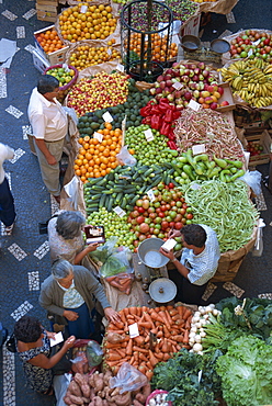 People at a fruit and vegetable stall in the market hall in Funchal, on the island of Madeira, Portugal, Europe