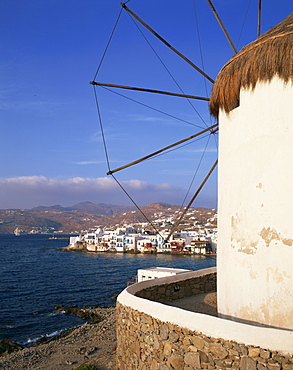 Thatched windmill with town and hills in the background on Mykonos, Cyclades Islands, Greek Islands, Greece, Europe