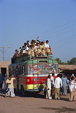 Overloaded bus with men riding on the roof near Multan in Pakistan, Asia