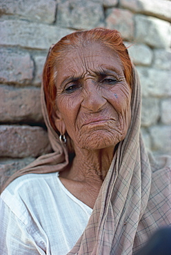 Portrait of an elderly woman with hair dyed red with henna, at Harappa, Punjab, Pakistan, Asia