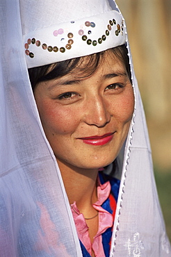 Portrait of a young woman in national dress, Otoraigur, near Balikchi, Kyrgyzstan, Central Asia, Asia