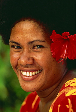 Portrait of a Melanesian girl with a red hibiscus flower in her hair on Qamea Island, Fiji, Pacific Islands, Pacific