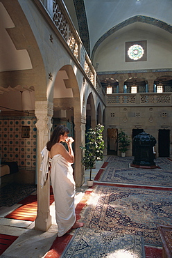 Woman drinking water in the Moorish bath house in the spa at Trenciaske Teplice, Slovakia, Europe