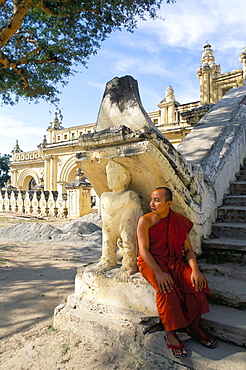 Monk at foot of staircase, Atumashi monastery, Mandalay, Myanmar (Burma), Asia