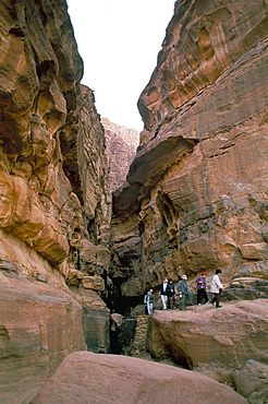 Japanese tourists in gorge with rock paintings, Wadi Rum, Jordan, Middle East