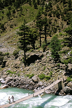 Men gossipping on bridge, near Kalam, Swat Valley, Pakistan, Asia