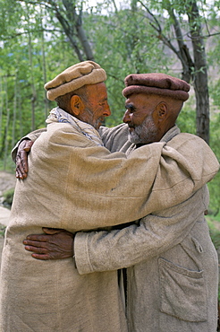 Nagari men hugging in traditional greeting, Nagar Valley, Pakistan, Asia