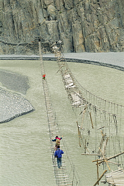 Swinging bridges over river, Bojal, near Passu, Pakistan, Asia