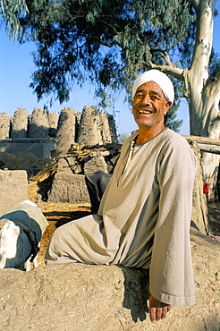 Friendly fellah with dovecotes behind, near Tanis, Delta area, Egypt, North Africa, Africa