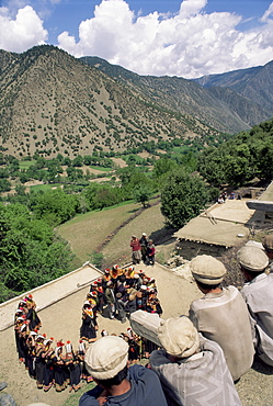 Men watching Kalash women dancing, Spring Festival, Joshi, Bumburet Valley, Pakistan, Asia