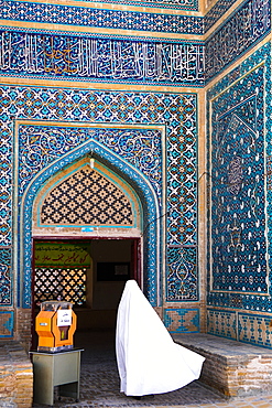 Woman in white chador enters Jameh Mosque, Varzaneh, Iran, Middle East