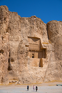 Tourists walking in front of Tomb of Darius the Great, Naqsh-e Rostam Necropolis, near Persepolis, Iran, Middle East