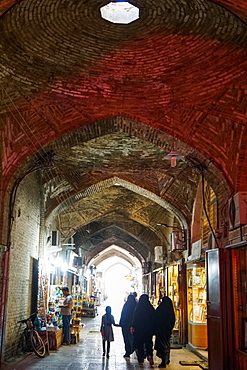 Girl and women in black chadors, Grand Bazaar, Isfahan, Iran, Middle East