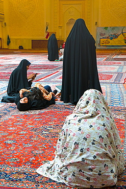 Women and child gathered, interior, Aramgah-e Shah-e Cheragh (Mausoleum of the King of Light), Shiraz, Iran, Middle East