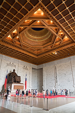 Soldier stands guard and tourists wander in front of large sitting statue of Chiang Kai-shek, Chiang Kai-shek Memorial Hall, Taipei, Taiwan, Asia