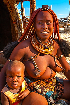 Red ochred, bare breasted Himba woman in traditional dress, with her child, Puros Village, near Sesfontein, Namibia, Africa