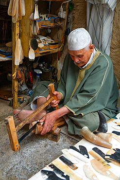 Man saws horn to make combs in an alleyway in the Old City (Medina) of Fez, UNESCO World Heritage Site, Morocco, North Africa, Africa