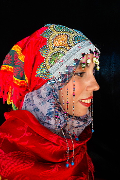 Close-up side portrait of beautiful young Moroccan woman in traditional Berber dress, in Chefchaouen, Morocco, North Africa, Africa