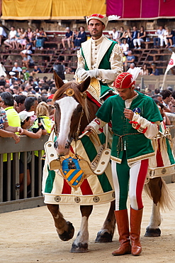 At the pageant that precedes the Palio race, representatives and riders of each neighbourhood parade in traditional costume, Siena, Tuscany, Italy, Europe