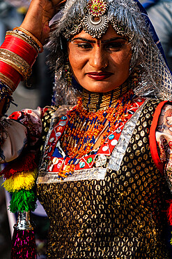 Dancer in brightly coloured traditional clothing in the inauguration procession for the Chandrabhaga Fair, Jhalawar, Rajasthan, India, Asia