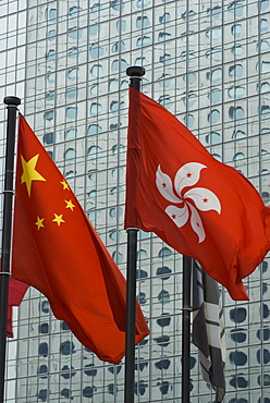 The Hong Kong and Chinese flags fly in Central, Hong Kong, China, Asia