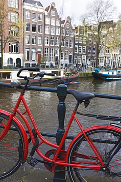 Red bicycle by the Herengracht canal, Amsterdam, Netherlands, Europe