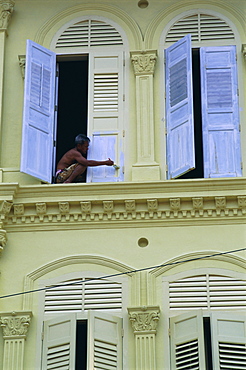 Man painting shutters on a house, Chinatown, Singapore, Asia