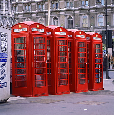 A line of four red telephone boxes at Charing Cross, London, England, United Kingdom, Europe