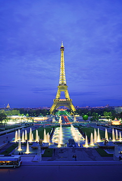 The Eiffel Tower with water fountains, illuminated at dusk, Paris, France, Europe