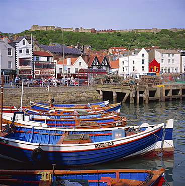 Fishing boats in the harbour, with the castle on the hill behind, Scarborough, Yorkshire, England, United Kingdom, Europe