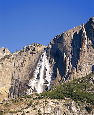 Waterfall cascades over rock wall at Upper Falls in the Yosemite National Park, California, USA 