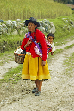 Portrait of a woman carrying her baby, central area, Peru, South America