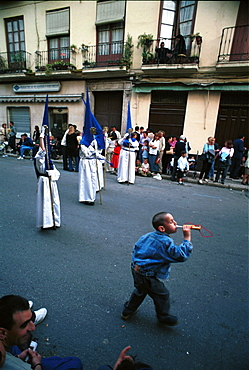 Malaga-Spain - Easter Week (Semana Santa) - A boy adding his own music to a procession 