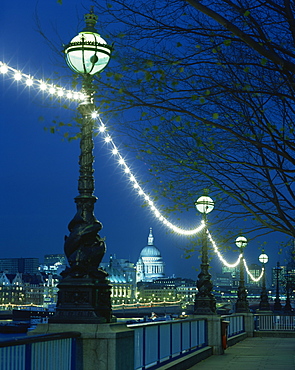 South Bank street lamps and city skyline, including St.Paul's Cathedral, illuminated at night, seen from across the Thames, London, England, United Kingdom, Europe