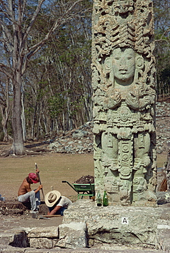 Two men excavating beside the Main Court Stela in the Mayan ruins at Copan, UNESCO World Heritage Site, Honduras, Central America