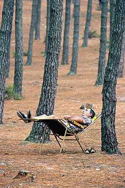 Man sleeping beneath trees, Aquitaine, France, Europe