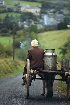 Figure riding cart with milk churn, Arigna, Shannon River, County Leitrim, Connacht, Republic of Ireland, Europe