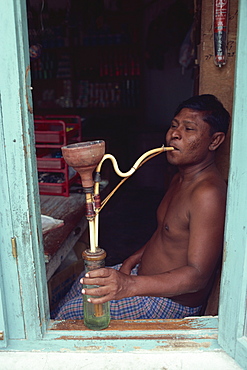 Shopkeeper with hookah, Male, Maldive Islands, Indian Ocean, Asia