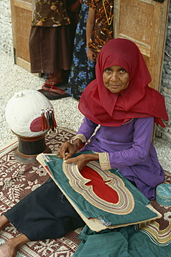 Woman sewing on a collar, Maldive Islands, Asia