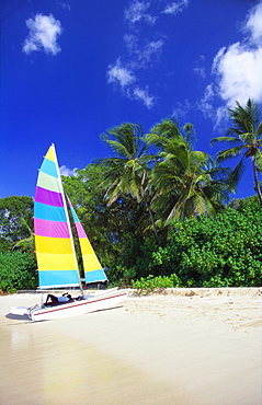 Man Lying on His Sailing Boat at St James Beach, Barbados, Caribbean