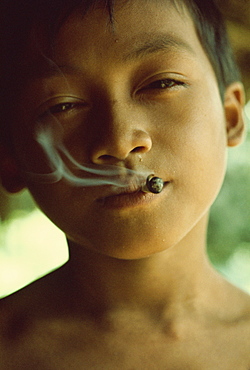 Kenyah boy smoking, Sarawak, Malaysia, Southeast Asia, Asia