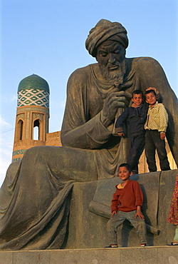 Children playing on statue of Uzbek poet, Khiva, Uzbekistan, Central Asia, Asia