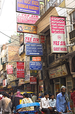 People riding rickshaws and street signs, Pahar Ganj, Main Bazaar, New Delhi, Delhi, India, Asia