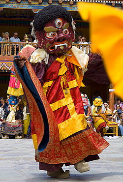 Monk in wooden mask in traditional costume, dancing in monastery courtyard, Hemis Festival, Hemis, Ladakh, India, Asia