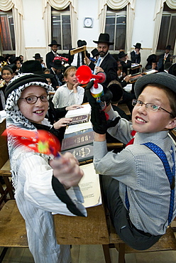 When Haman's name is read out during the public chanting of the Megillah in the synagogue, which occurs 54 times, the congregation engages in noisemaking to blot out his name, Purim Festival, Ramat Beit Shemesh, Israel, Middle East