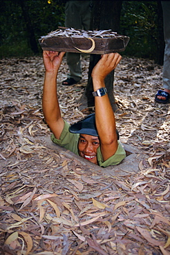 Vietnamese man entering tunnel, Chu Chi tunnels, Vietnam, Indochina, Southeast Asia, Asia