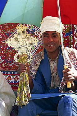 Priest fund raising for church restoration, at side of road in the Simien Mountains, Ethiopia, Africa