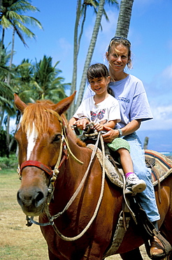 Mother and child horseriding, Molokal, Hawaiian Islands, United States of America, North America