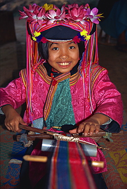 Hill tribe girl weaving on a narrow loom in Chiang Mai, Thailand, Southeast Asia, Asia