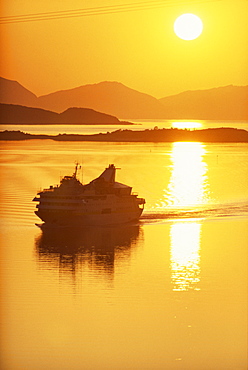 Ferry silhouetted by the midnight sun, Harstad, Norway, Scandinavia, Europe